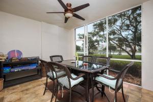 a dining room with a table and chairs and a ceiling fan at Palm Coast Resort 109 in Palm Coast