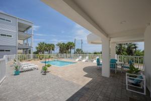 a patio with a pool and chairs and a house at Endless Views, 4 Bedrooms, Wi-Fi, Ocean View, Private Pool, Sleeps 12 in Saint Augustine
