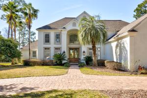 a house with a palm tree in the driveway at Players Choice in Ponte Vedra