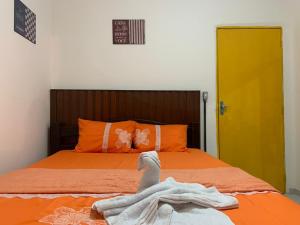 a bedroom with a bed with a towel on it at Pousada 461 in Recife