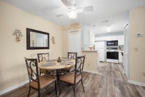 a dining room with a table and chairs and a kitchen at Ponte Vedra Colony Circle 75, 2 Bedrooms, Sleeps 4 in Ponte Vedra