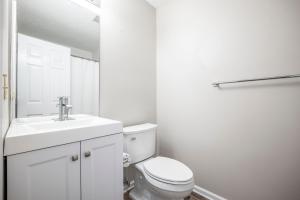 a white bathroom with a toilet and a sink at Ponte Vedra Colony Circle 75, 2 Bedrooms, Sleeps 4 in Ponte Vedra