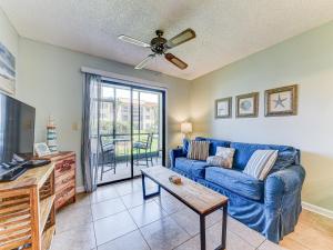 a living room with a blue couch and a table at Ocean Village Club N16, 1 Bedroom, Sleeps 4, Heated Pool, WiFi in Saint Augustine