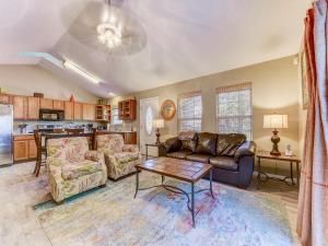 a living room with a couch and a table at Averys Beach Bungalow in Butler Beach