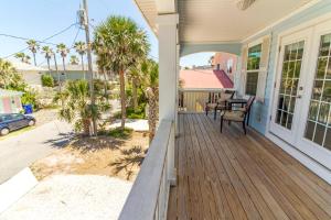 a front porch of a house with a wooden deck at Averys Ocean Breeze in Butler Beach