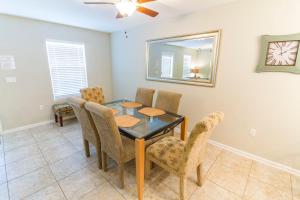 a dining room with a table and chairs and a mirror at Averys Ocean Breeze in Butler Beach