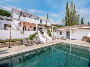 a villa with a swimming pool and a house at Exclusive historic Villa in the heart of Andalucian - La Villa Magdalena in Ronda