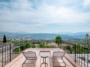 a patio with chairs and a table on a balcony at Exclusive historic Villa in the heart of Andalucian - La Villa Magdalena in Ronda