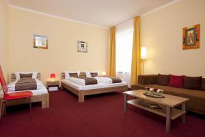 a living room with two beds and a couch at Apartment Abendstern in Berlin