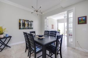 a dining room with a black table and chairs at Beaches n Fairway Getaway in Ponte Vedra
