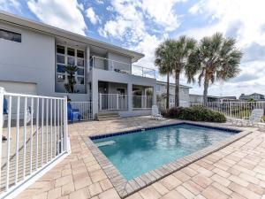 a house with a swimming pool in front of a house at Ocean Pearl, 4 Bedrooms, Sleeps 13, Private Pool, Ocean Front in St. Augustine