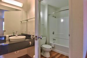 a bathroom with a white toilet and a sink at Motel 6-Sacramento, CA - South Sacramento and Elk Grove in Sacramento +37 photos