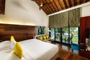 a bedroom with a large bed and a large window at The Fortress Resort & Spa in Koggala