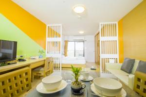 sala de estar con paredes amarillas y verdes en Sitara Place Serviced Apartment & Hotel en Bangkok