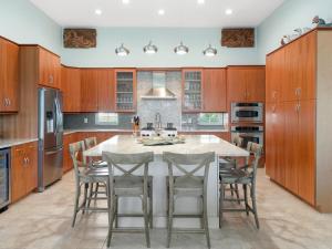 a kitchen with a large island with chairs around it at Kokomo Key in Palm Coast