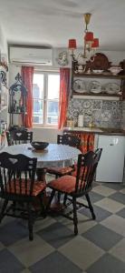 a kitchen with a table and two chairs and a table and a table at Vintage House for rent 60m from Sea in Baška Voda