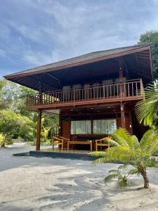 ein Haus mit einem Balkon am Strand in der Unterkunft Leebong Island Resort in Leebong