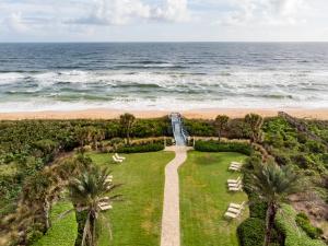 an aerial view of the beach with a pathway to the ocean at 832 Cinnamon Beach in Palm Coast +37 photos