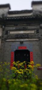 una puerta con un ramo de flores delante de ella en WuYuan QiYe YanXiang Guesthouse, en Wuyuan