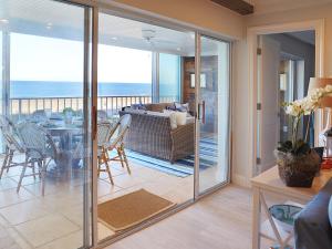 a living room with sliding glass doors leading to a patio at Ponte Vedra Ocean Manor 106-D, 3 Bedrooms, Beachfront, Sleeps 10 in Ponte Vedra