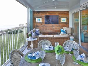 a patio with a table and chairs on a balcony at Ponte Vedra Ocean Manor 106-D, 3 Bedrooms, Beachfront, Sleeps 10 in Ponte Vedra