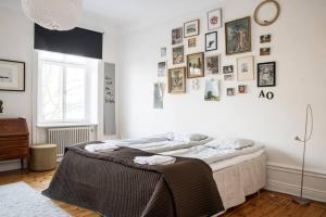 a bedroom with a large bed with pictures on the wall at Exclusive and light 3 room appartment in SoFo 97sqm in Stockholm