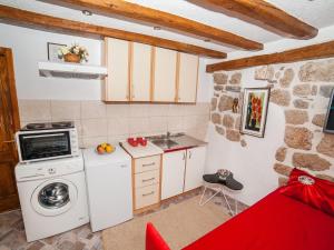 a small kitchen with a washer and a stove at Apartment Alexandra in Kotor
