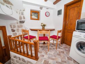 a kitchen with a table and chairs and a washing machine at Apartment Alexandra in Kotor