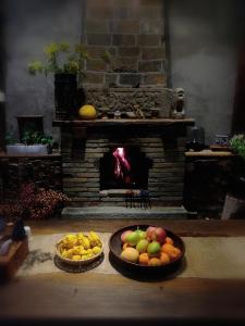 two baskets of fruit in front of a fireplace at WuYuan QiYe YanXiang Guesthouse in Wuyuan