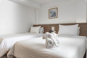 Voodi või voodid majutusasutuse Sovereign Group Hotel at Pratunam toas