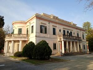 a large white building with a balcony on a street at Akis Garden in Anemómylos