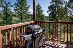 a stove on a balcony with a view of trees at Adobe Hacienda, 3 Bedrooms, Sleeps 8, Gas Grill, Fenced Yard, WiFi in Ruidoso