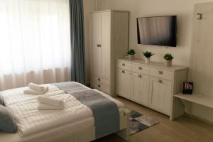 A bed or beds in a room at Munkácsy Villa - Szekszárd