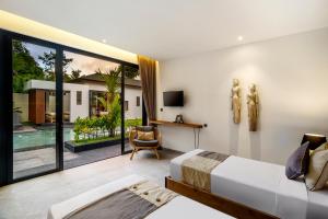 a bedroom with a king sized bed and a tv at Villa Lagoon by BaliSuperHost in Ubud +28 photos