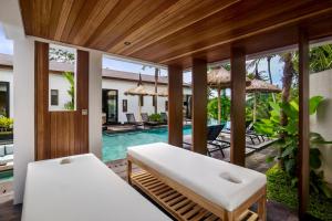 a room with a bed and a swimming pool at Villa Lagoon by BaliSuperHost in Ubud