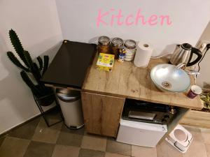 a kitchen with a wooden counter with a kitchen sign on the wall at SPACE ART BOUTIQUE Downtown in Jerusalem