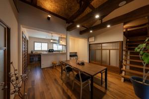 une chambre avec une table à manger et une cuisine accessible par un escalier. dans l'établissement OMISHIMA SPACE Omoya, à Imabari