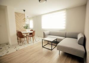 a living room with a couch and a table at Dusa Zlatibora in Zlatibor