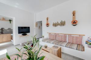 a living room with a couch and a tv at Endless Blue from Syros - Vari Resort in Vári