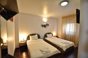 Un pat sau paturi într-o cameră la Hotel Euphoria