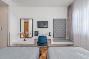 Ένα ή περισσότερα κρεβάτια σε δωμάτιο στο Hotel Pax