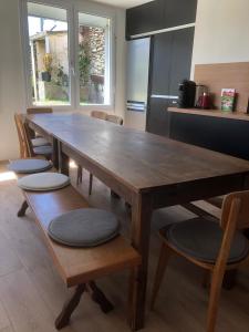 a wooden table and chairs in a kitchen at Maison les figuiers Roch Priol in Quiberon
