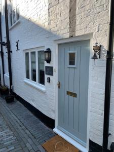 a white door on the side of a building at Bell Cottage right in the heart of Bridgnorth in Bridgnorth