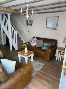 a living room with a couch and a table at Bell Cottage right in the heart of Bridgnorth in Bridgnorth