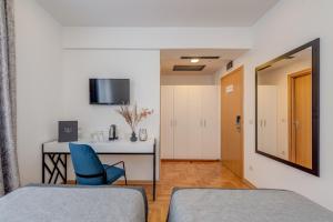 Ένα ή περισσότερα κρεβάτια σε δωμάτιο στο Hotel Pax