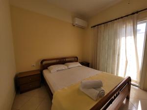 a bedroom with a bed with two towels on it at Mihasi Apartments in Ksamil