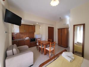 a living room with a couch and a table at Mihasi Apartments in Ksamil