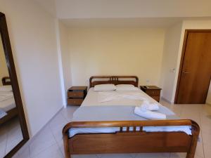 a bedroom with a bed with two towels on it at Mihasi Apartments in Ksamil