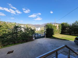 a driveway with a gate and a fence at Mihasi Apartments in Ksamil