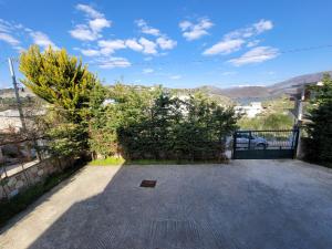 a backyard with a gate and trees and a fence at Mihasi Apartments in Ksamil